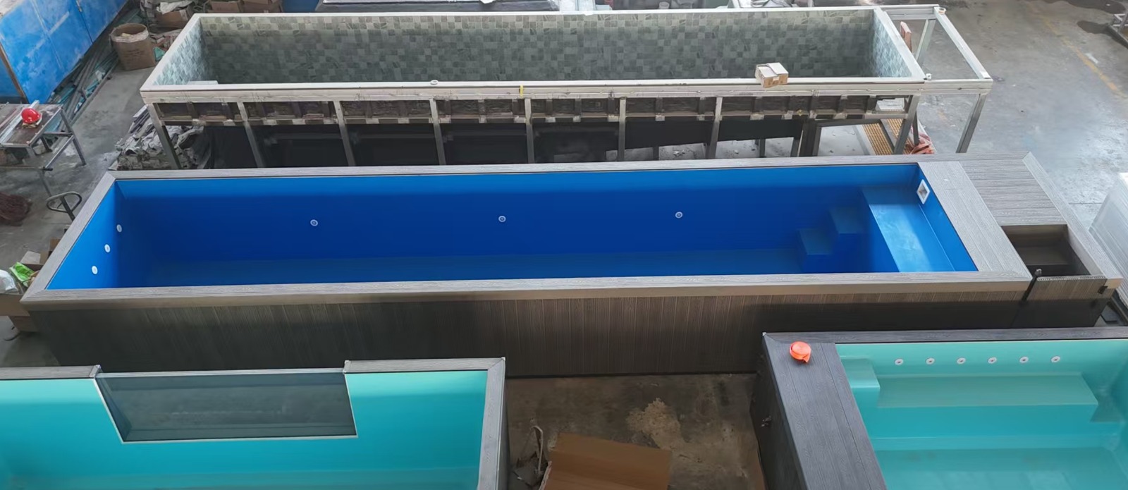 40ft blue fibreglass pool with grey WPC surround in the factory